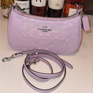 Teri Shoulder Bag in Signature embossed leather in Lilac color with heart charm